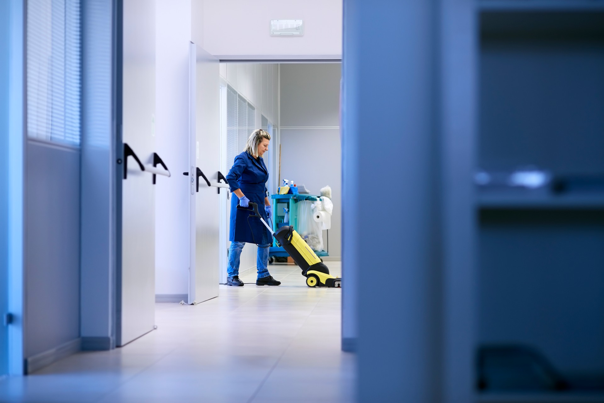 Women at workplace, professional female cleaner washing floor in office